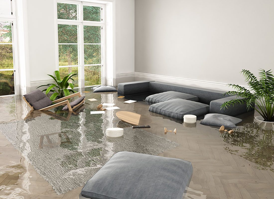 Flood Insurance - View of a Flooded Living Room in a Home with Pillows and Multiple Small Items Floating in the Water